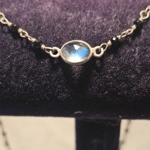 925 & BLACK DIAMONDS WITH  WHITE TOPAZ ADORN THIS STERLING SILVER NECKLACE.